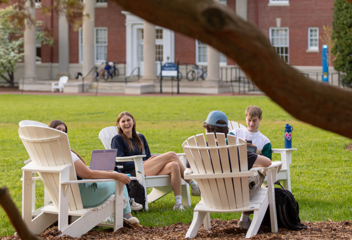 students sit outdoors in chairs on UMW campus