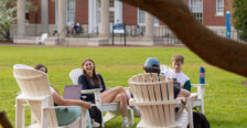 students sit outdoors in chairs on UMW campus