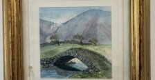 A watercolor painting of a cobblestone bridge with mountains in the backrgound