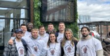 A group of UMW alumni wearing matching Kahn Ball T-shirts outside a brewery.