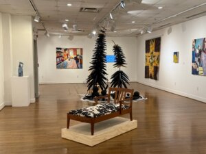Works of art displayed on walls and sculpture situated around a room
