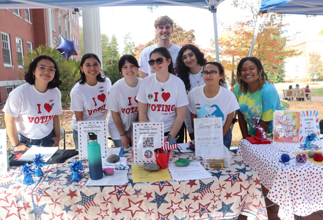 Several students pose for the camera wearing "I heart voting" T-shirts