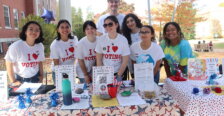 Several students pose for the camera wearing "I heart voting" T-shirts