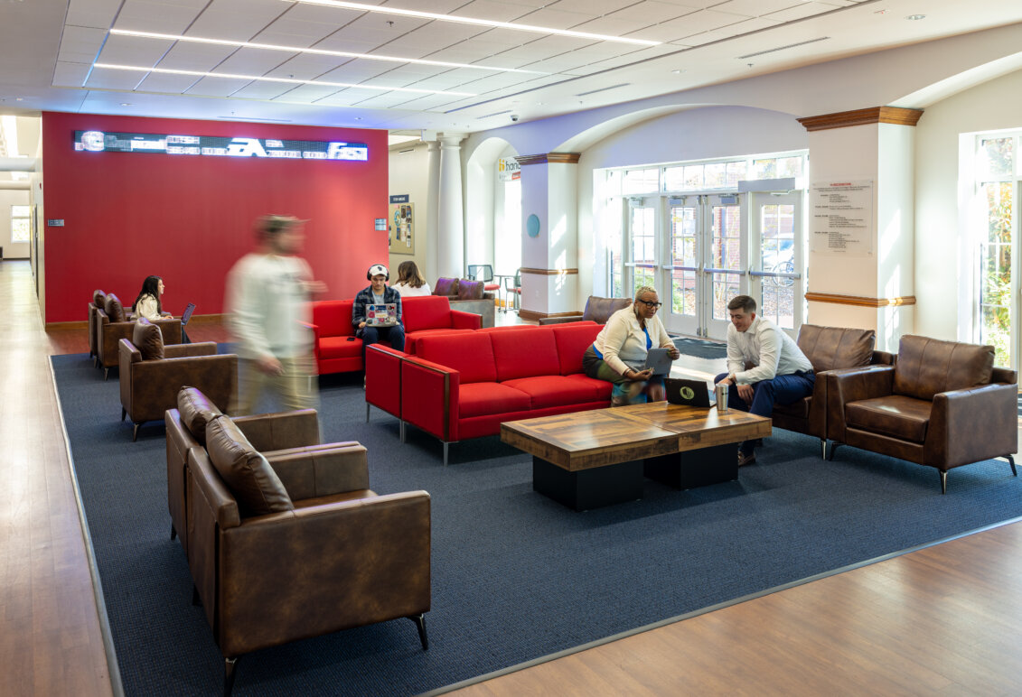Students and faculty gather in the College of Business lobby.