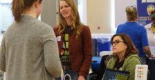 Three women talk during a career fair