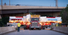 A tractor trailer transporting a giant piece of technology for a physics experiment.