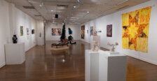 Works of art displayed on walls and sculpture situated around a room