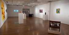 Works of art displayed on walls and sculpture situated around a room