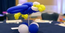 A balloon sculpture in the shape of an Eagle sits in the center of a table
