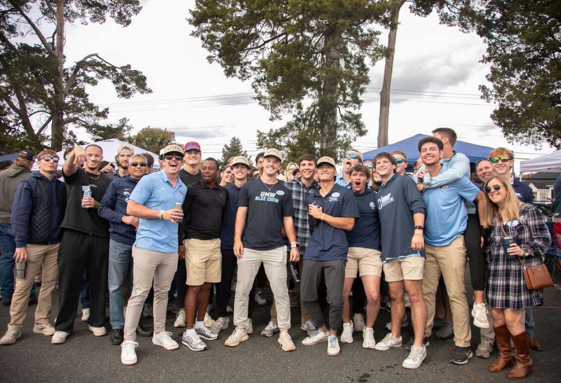 Families and friends wearing Mary Wash merchandise gather at the Homecoming Tailgate.