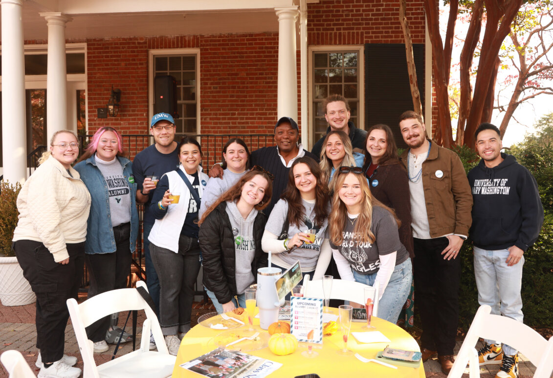 Alumni pose with Cedric Rucker &rsquo;81, Associate Vice President for Student Affairs and Dean of Student Life, at the Pregame Brunch.