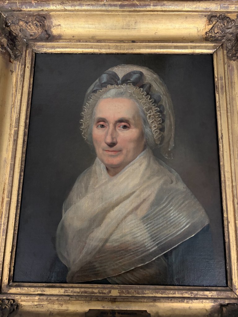A painting of Mary Washington featuring George Washington's face painted on his mother's body.