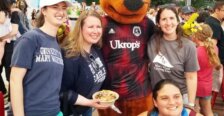 A group of four people and a kangaroo mascot.