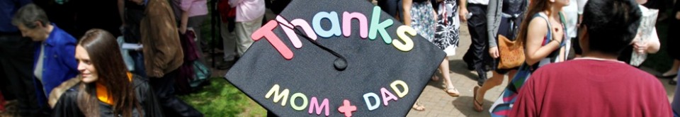 A student's graduation cap with the phrase, "Thanks mom and dad," on it.