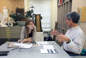 Student at table with faculty