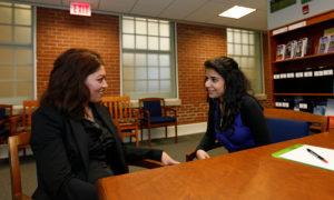 Leila Asadi, the visiting human scholar from Iran, is working with a student Shirin Afsous on human rights issues in Islam, Monday Jan 30, 2012. Posed situation.(Photo by Norm Shafer).