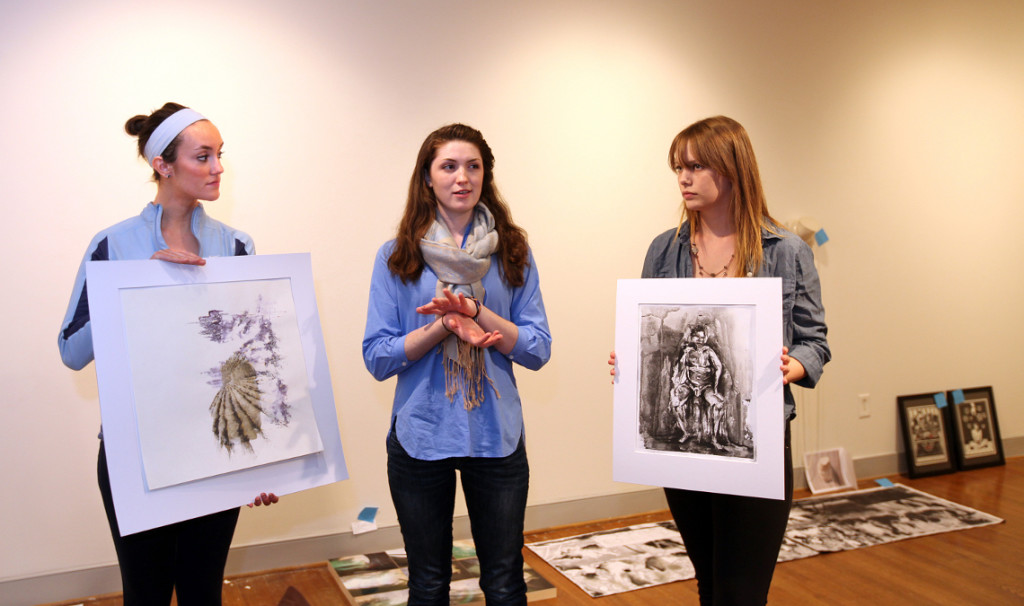 Students discuss their work for the upcoming student art show in Melchers Gallery.