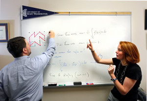 Math professor Randall Helmstutler is working with sophomore Claire Gianelle on a research project connecting multivariable calculus to a famous old theorem in geometry. This project is part of the university’s URES 197 program that focuses on research for students at any level. Monday Jan. 30, 2012. Posed situation. (Photo by Norm Shafer).
