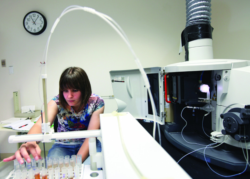 Jenna Stockton watches as a soil sample is analysed by a inductively coupled plasma atomic emission spectrometer in a lab at UMW. Assistant Professor Dr. Melanie Szulczewski is working on a research project with several UMW students tracking heavy metal concentrations in soil upstream and downstream from a closed pyrite mine along Contrary Creek in Louisa County. Photographerd, Monday, June 24, 2013. (Photo by Norm Shafer).