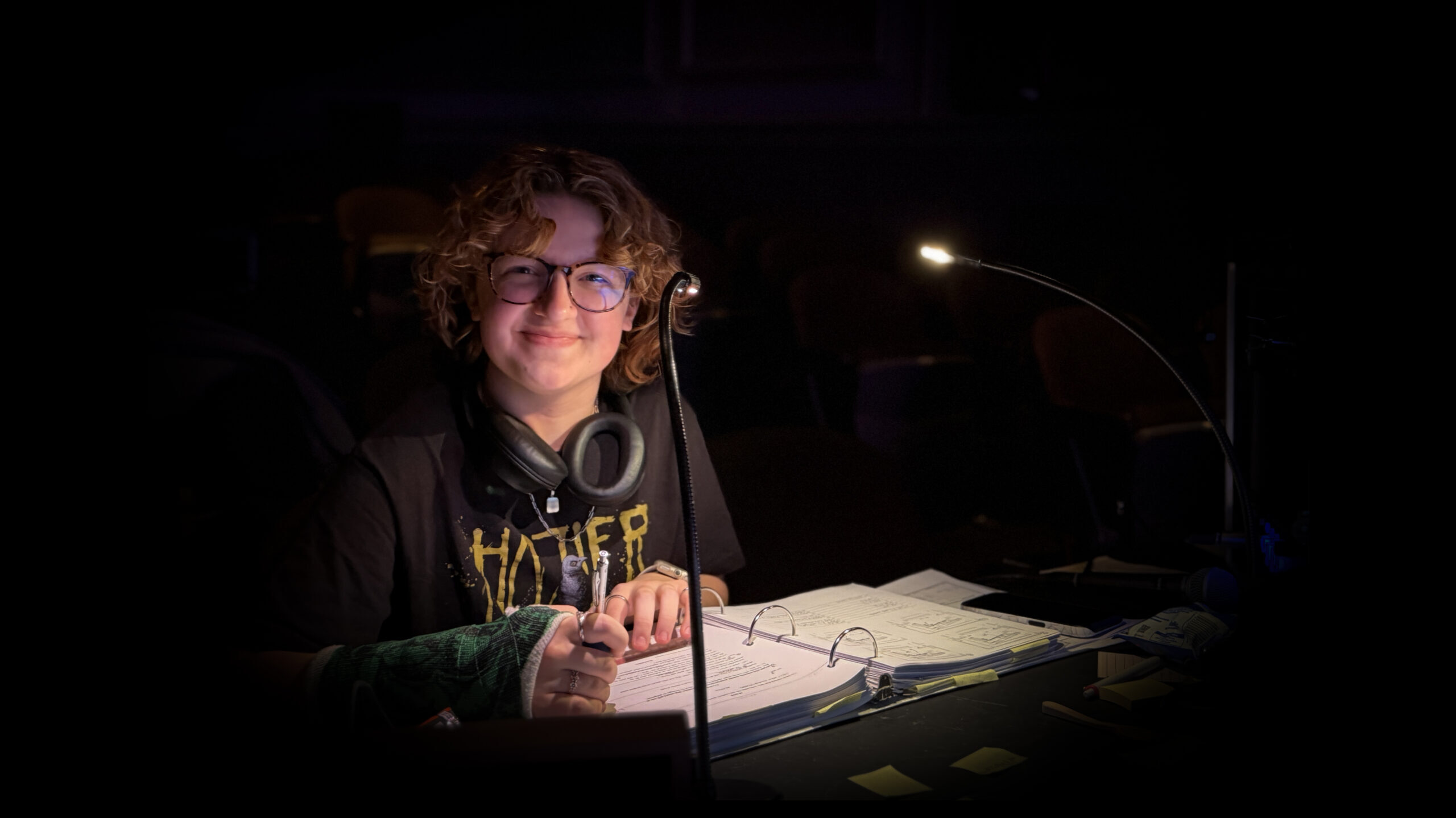 Student reviewing script materials for a show.
