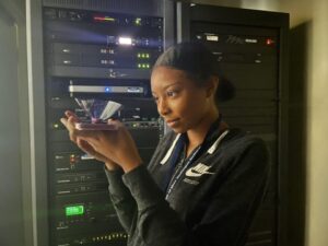 A student observes a hologram from her phone during a digital studies summer enrichment course in 2022